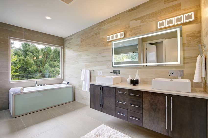 Bathroom with a large custom mirror above double sinks