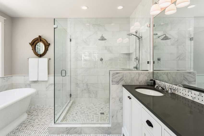 Frameless glass shower enclosure with a walk-in shower